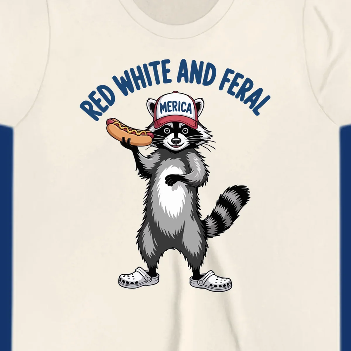 A patriotic raccoon in a MERICA hat and Crocs holds a hot dog, with 'RED WHITE AND FERAL' text. Features the red-white-feral-raccoon concept.
