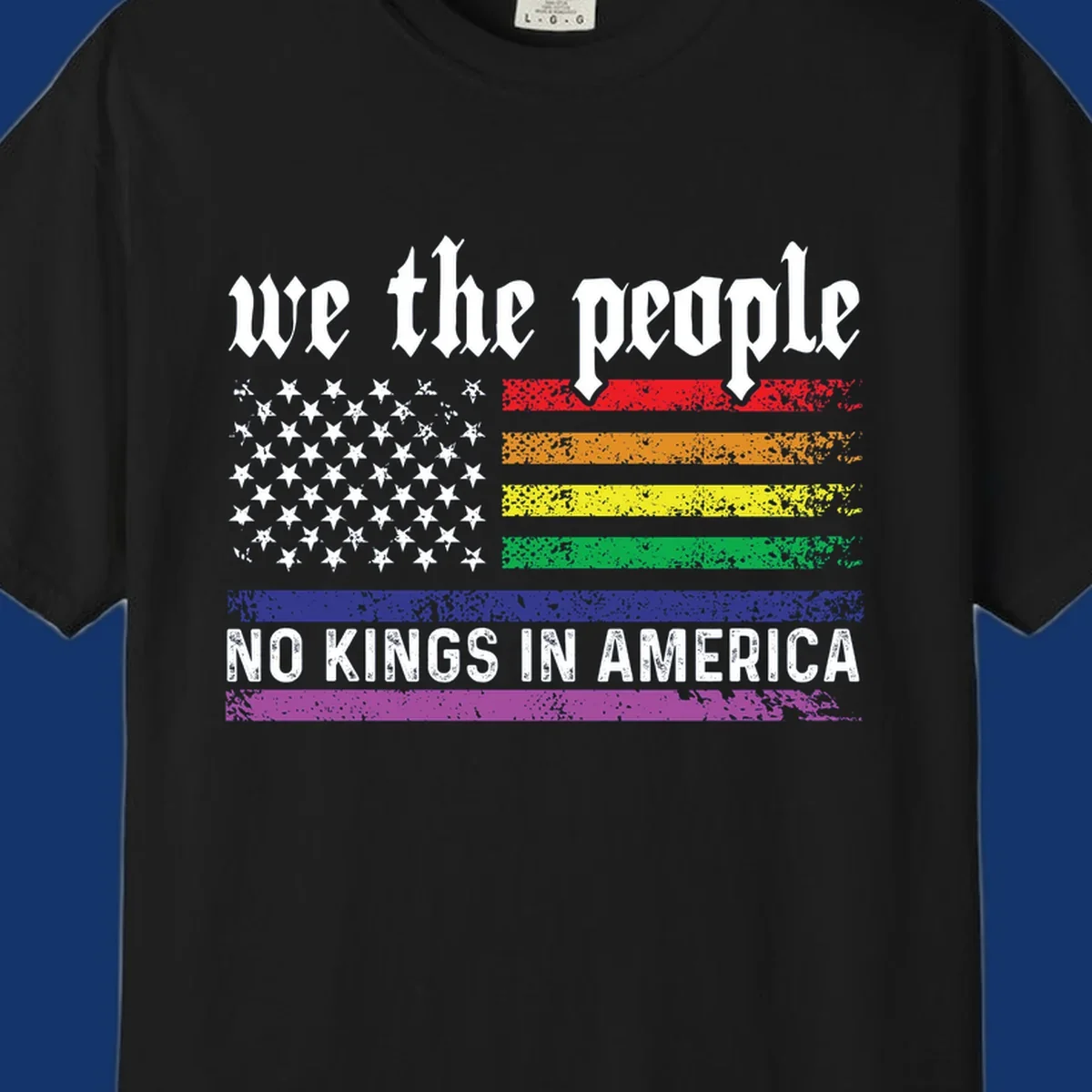 A distressed American flag with rainbow stripes and white stars, featuring 'we the people' and 'NO KINGS IN AMERICA' text.