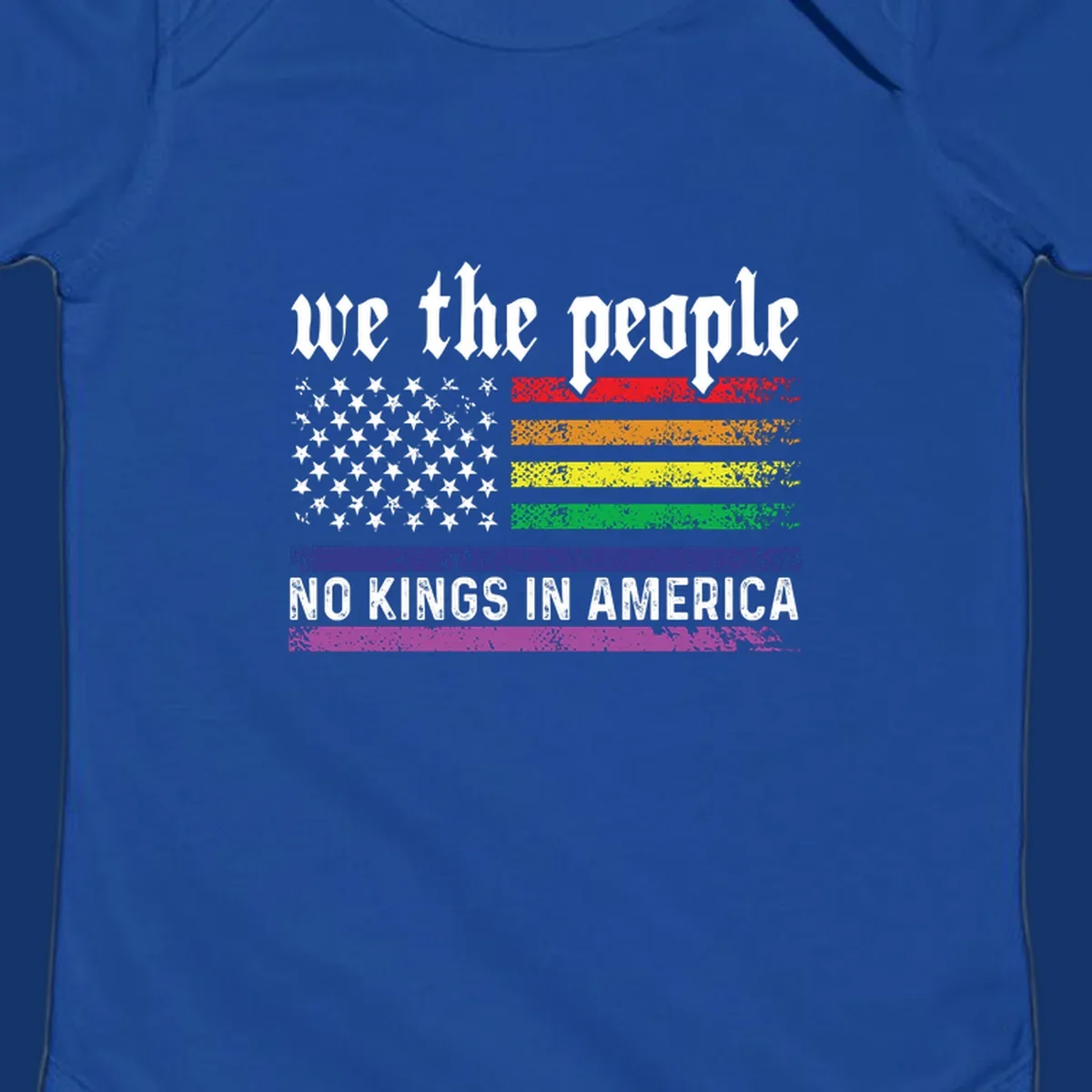 A distressed American flag with rainbow stripes and white stars, featuring 'we the people' and 'NO KINGS IN AMERICA' text.