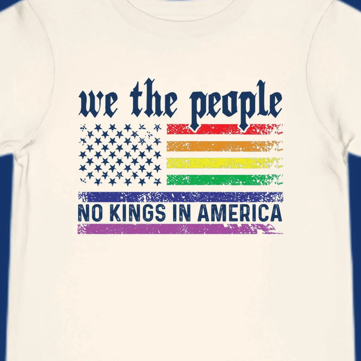 A distressed American flag with rainbow stripes and white stars, featuring 'we the people' and 'NO KINGS IN AMERICA' text.