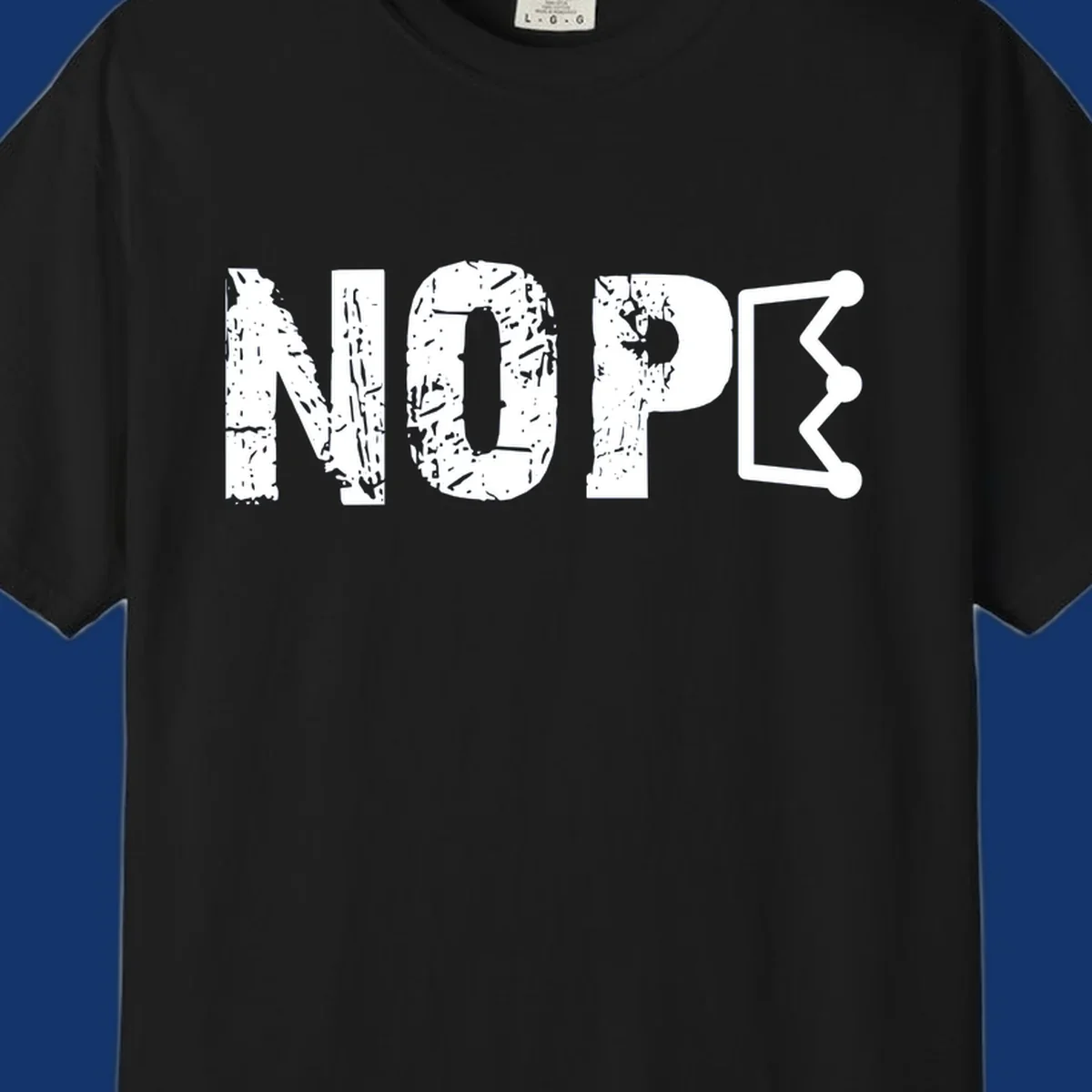 A distressed 'NOPE' text design where the 'E' is a crown outline, clean on all garment colors.