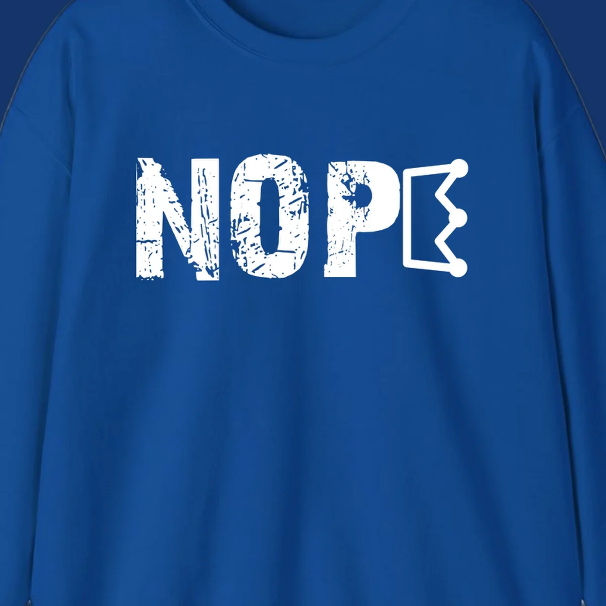 A distressed 'NOPE' text design where the 'E' is a crown outline, clean on all garment colors.