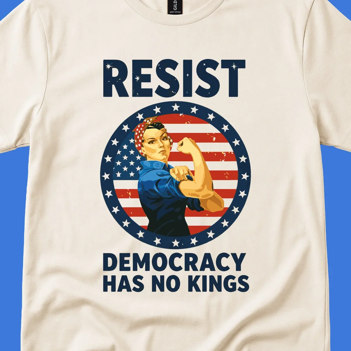 A Rosie the Riveter-style woman flexing her arm against a distressed American flag, with 'RESIST' and 'DEMOCRACY HAS NO KINGS' text. This design embodies the rosie-riveter-resist concept.