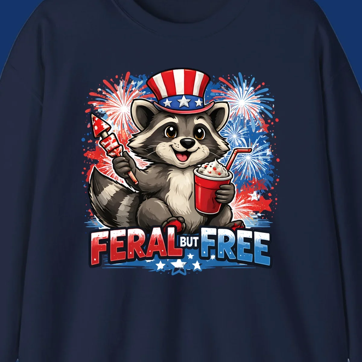 A cartoon raccoon in an Uncle Sam hat holds a firework and drink, with red, white, and blue fireworks and "FERAL BUT FREE" text.