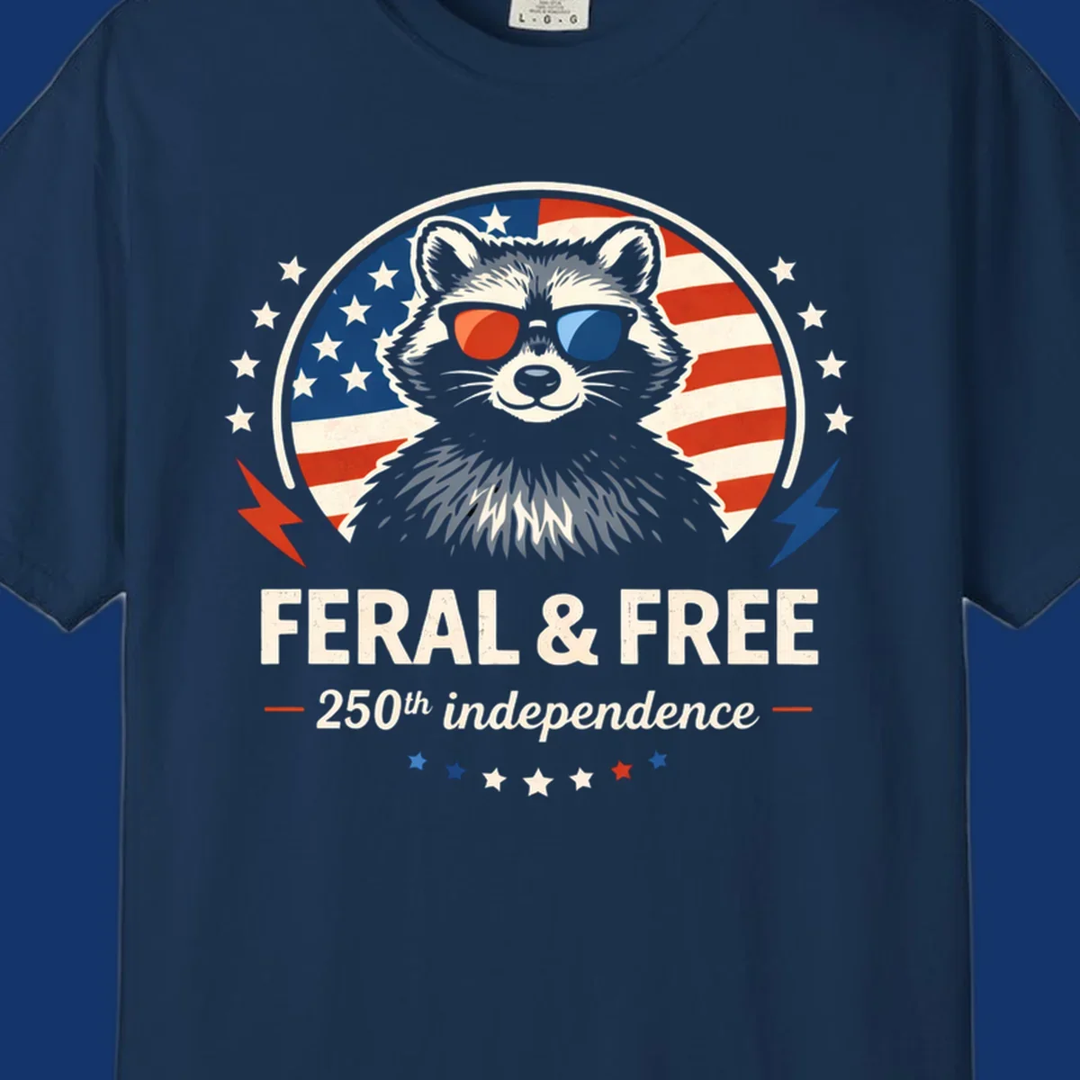 A patriotic design with a raccoon in red and blue sunglasses against an American flag, with text 'Feral & Free 250th Independence'.