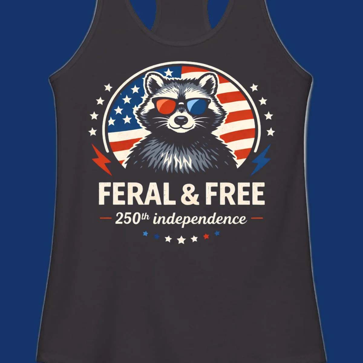A patriotic design with a raccoon in red and blue sunglasses against an American flag, with text 'Feral & Free 250th Independence'.