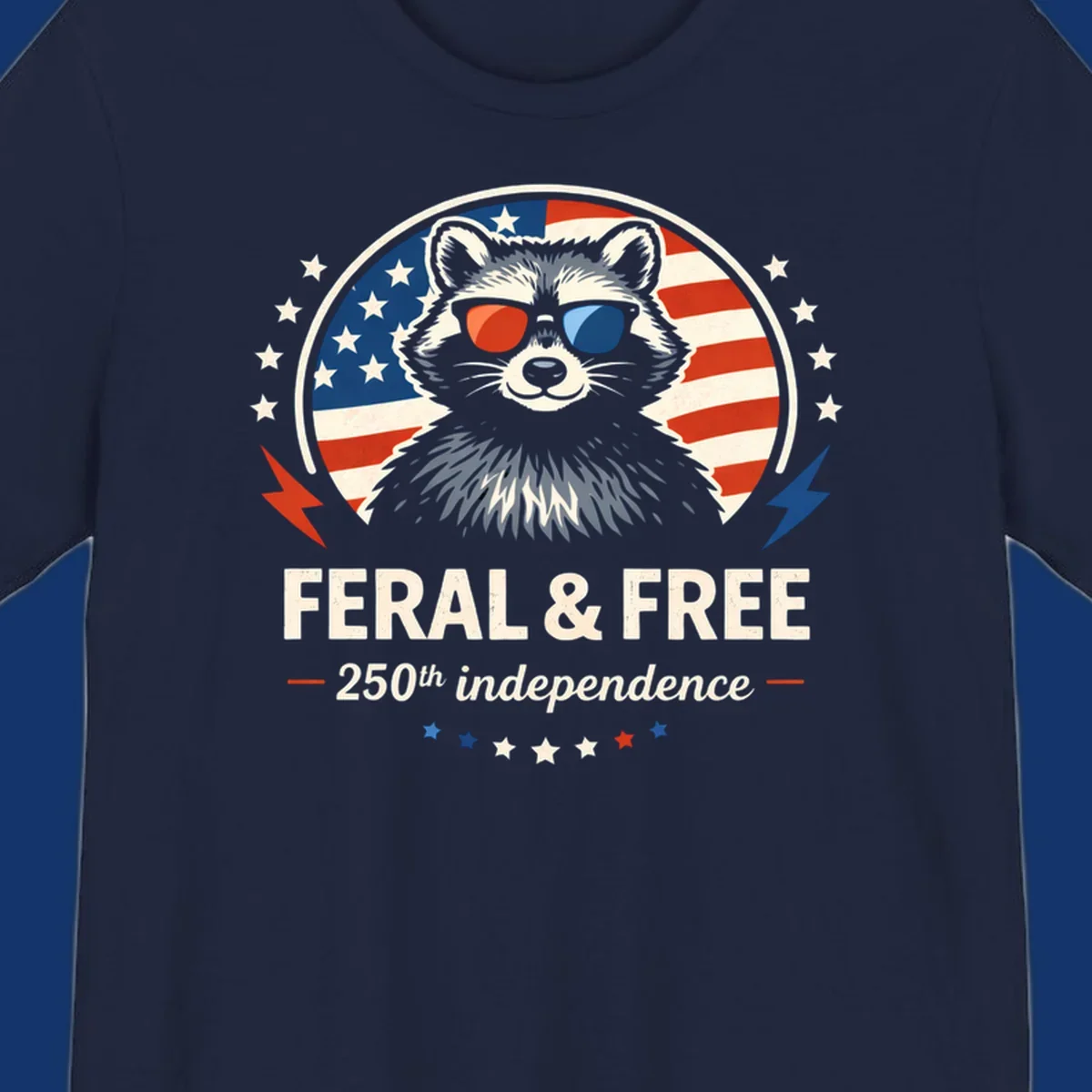 A patriotic design with a raccoon in red and blue sunglasses against an American flag, with text 'Feral & Free 250th Independence'.