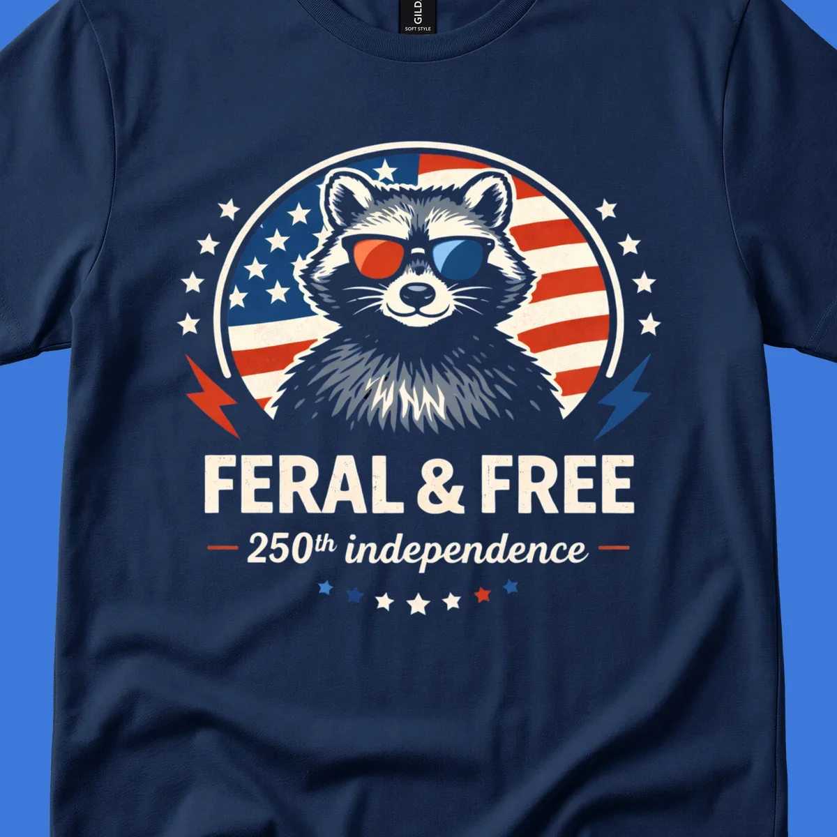 A patriotic design with a raccoon in red and blue sunglasses against an American flag, with text 'Feral & Free 250th Independence'.