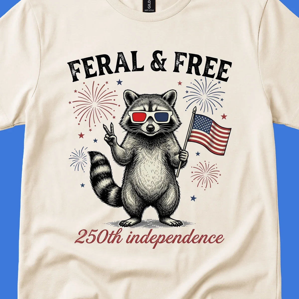 An illustrated raccoon in 3D glasses with an American flag and fireworks, text says 'Feral & Free 250th independence'.
