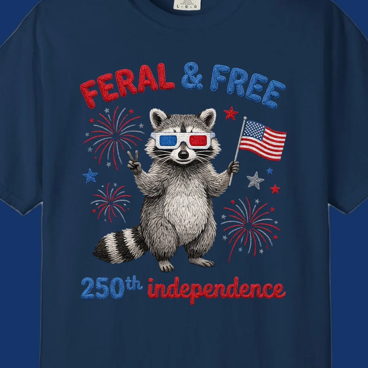 A playful raccoon in 3D glasses holds an American flag, surrounded by fireworks and stars, with "FERAL & FREE 250th independence".