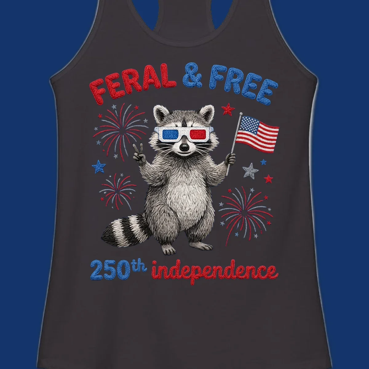 A playful raccoon in 3D glasses holds an American flag, surrounded by fireworks and stars, with "FERAL & FREE 250th independence".