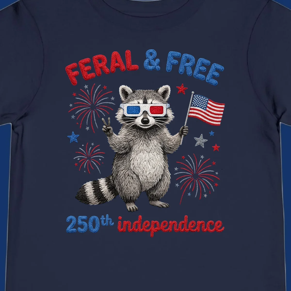 A playful raccoon in 3D glasses holds an American flag, surrounded by fireworks and stars, with "FERAL & FREE 250th independence".