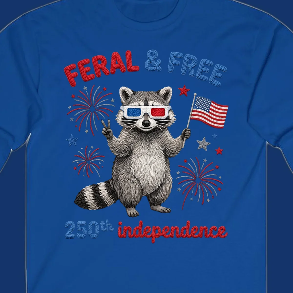 A "FERAL & FREE" raccoon in 3D glasses holds an American flag, surrounded by fireworks, celebrating 250th independence.