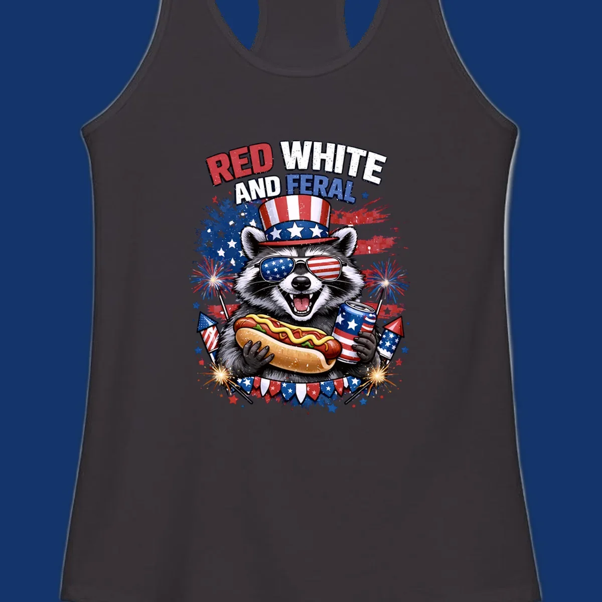 A patriotic raccoon wearing an American flag top hat and sunglasses, holding a hot dog and soda can, with the text 'RED WHITE AND FERAL' and fireworks.