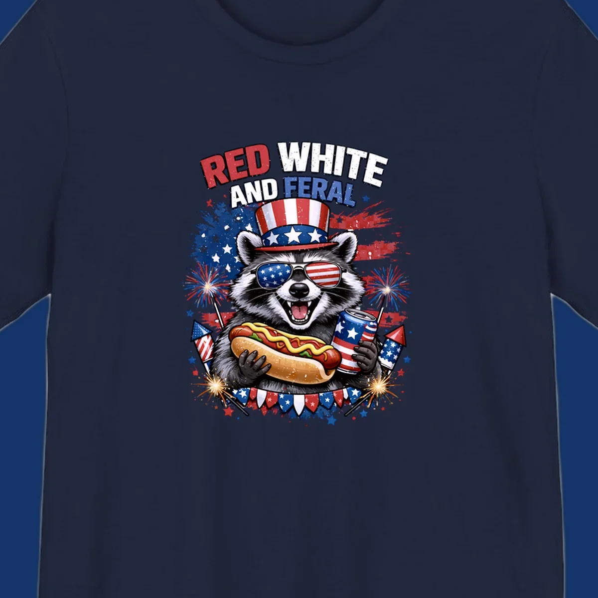 A patriotic raccoon wearing an American flag top hat and sunglasses, holding a hot dog and soda can, with the text 'RED WHITE AND FERAL' and fireworks.