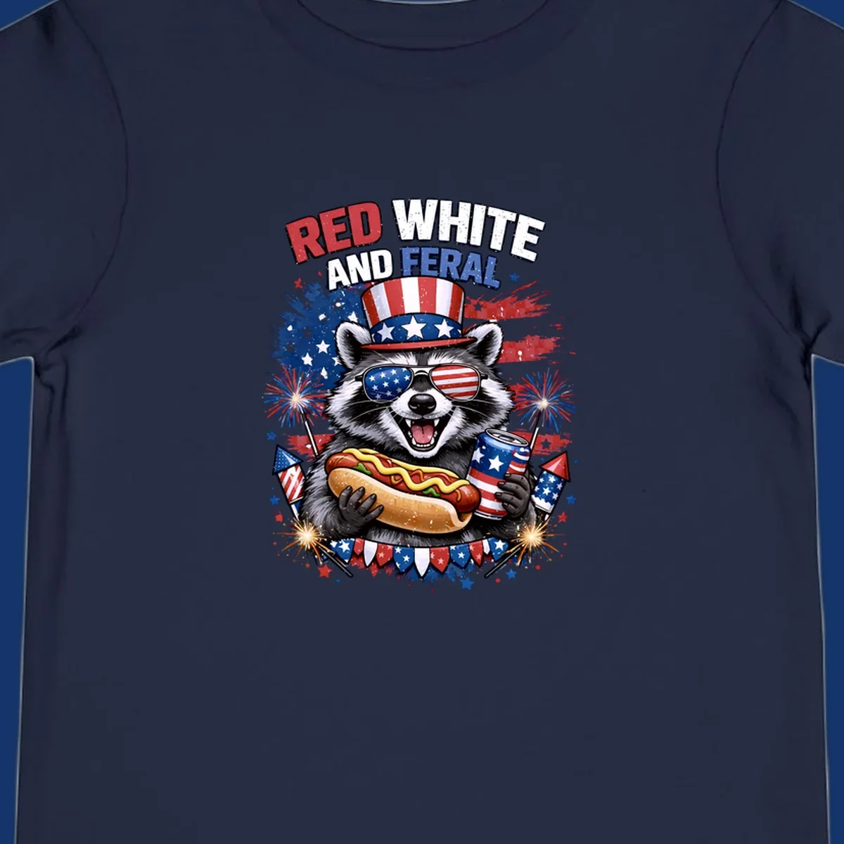 A patriotic raccoon wearing an American flag top hat and sunglasses, holding a hot dog and soda can, with the text 'RED WHITE AND FERAL' and fireworks.