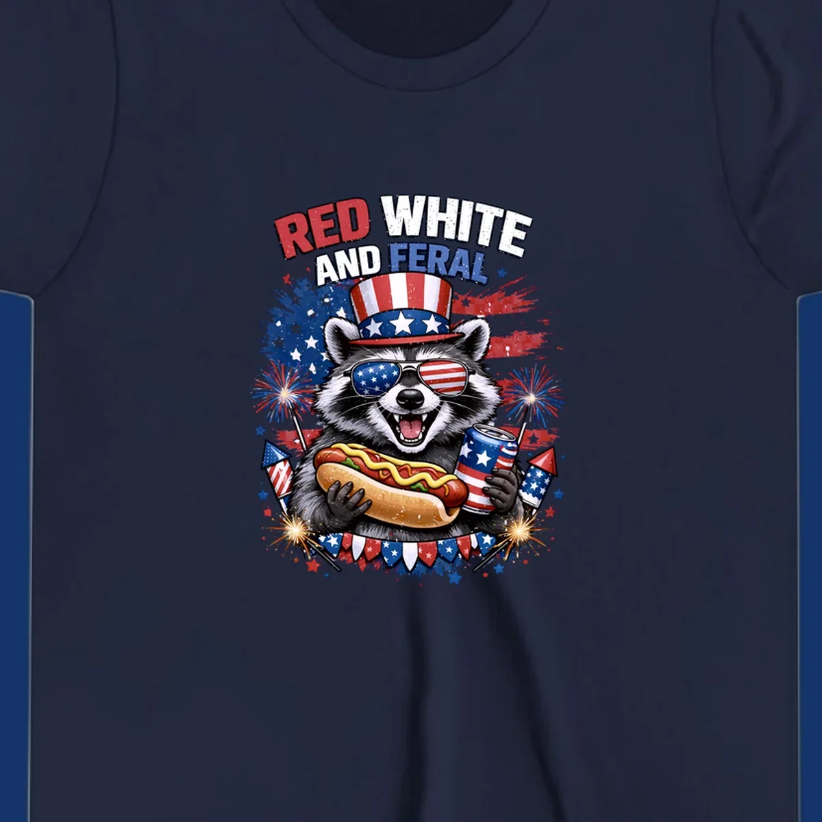 A patriotic raccoon wearing an American flag top hat and sunglasses, holding a hot dog and soda can, with the text 'RED WHITE AND FERAL' and fireworks.