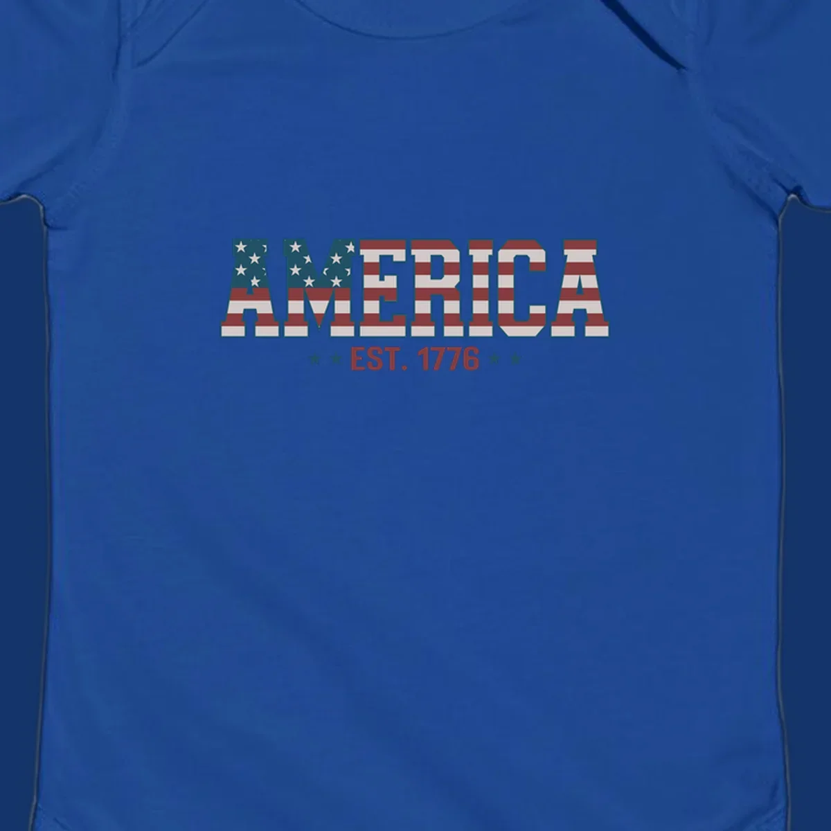 The word AMERICA in block letters, filled with an American flag pattern, above the text EST. 1776 with stars. Concept: america-est-1776-flag.