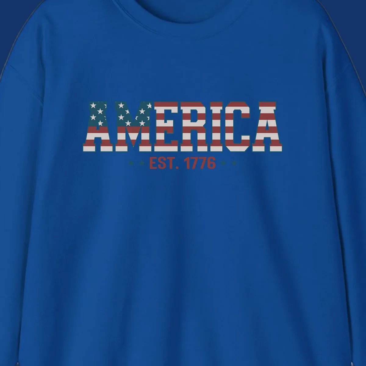 The word AMERICA in block letters, filled with an American flag pattern, above the text EST. 1776 with stars. Concept: america-est-1776-flag.