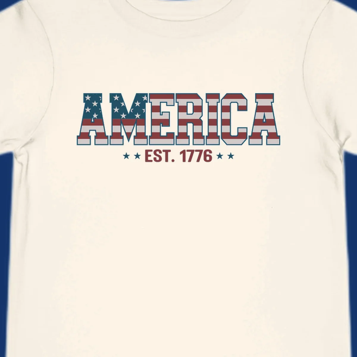 The word AMERICA in block letters, filled with an American flag pattern, above the text EST. 1776 with stars. Concept: america-est-1776-flag.