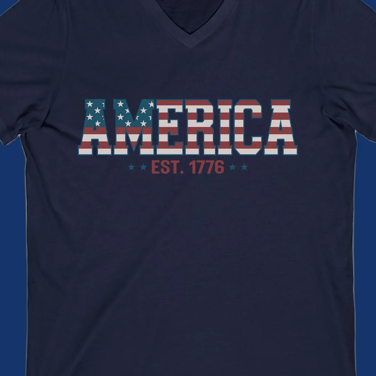 The word AMERICA in block letters, filled with an American flag pattern, above the text EST. 1776 with stars. Concept: america-est-1776-flag.