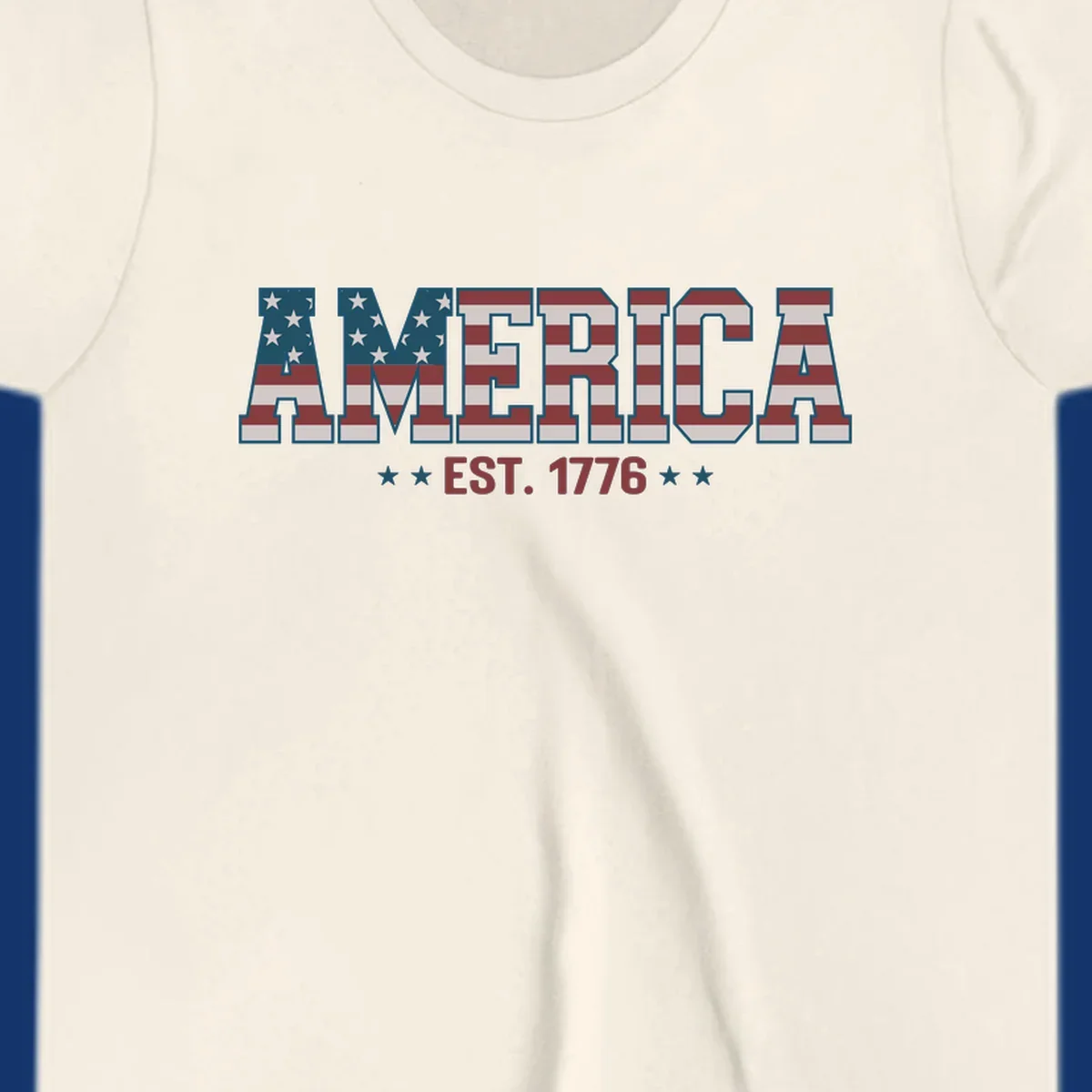 The word AMERICA in block letters, filled with an American flag pattern, above the text EST. 1776 with stars. Concept: america-est-1776-flag.