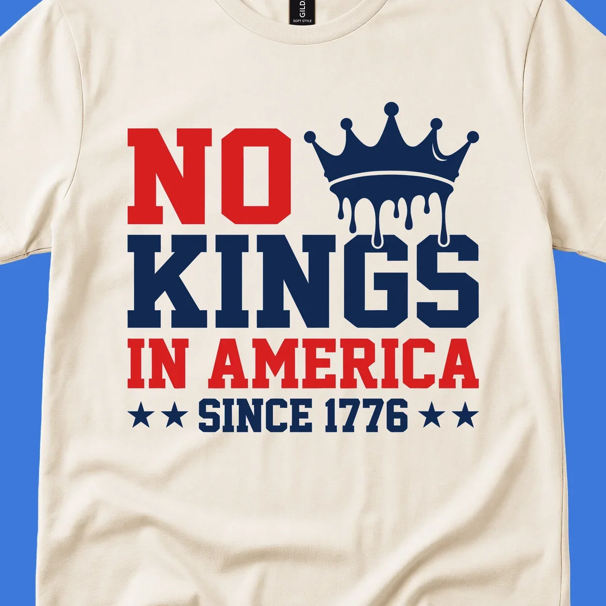 A patriotic design with text "NO KINGS IN AMERICA SINCE 1776" and a dripping blue crown, celebrating American independence.