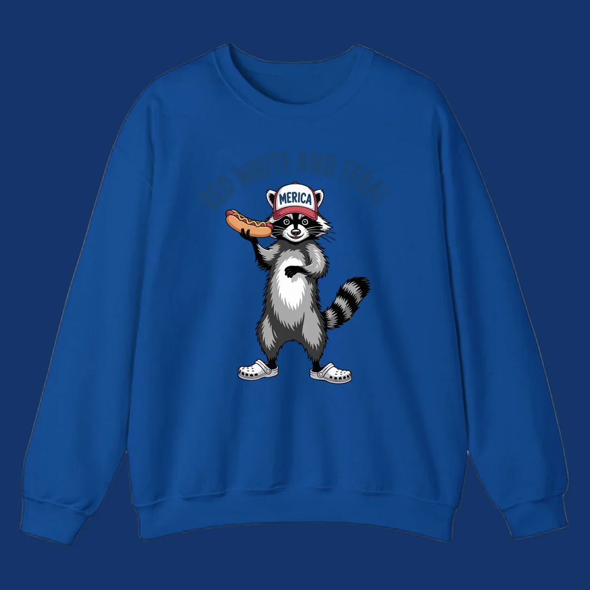 A patriotic raccoon in a MERICA hat and Crocs holds a hot dog, with 'RED WHITE AND FERAL' text. Features the red-white-feral-raccoon concept.