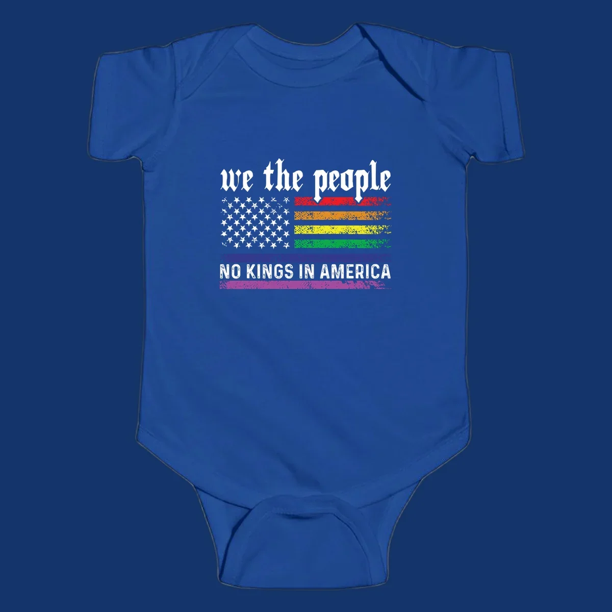 A distressed American flag with rainbow stripes and white stars, featuring 'we the people' and 'NO KINGS IN AMERICA' text.