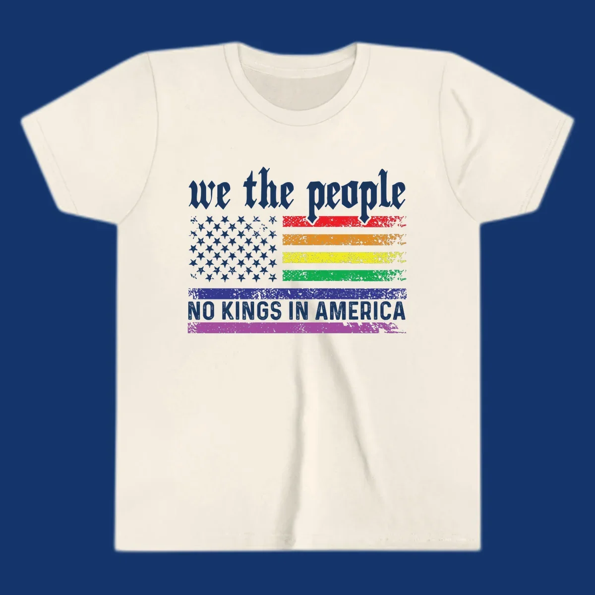 A distressed American flag with rainbow stripes and white stars, featuring 'we the people' and 'NO KINGS IN AMERICA' text.
