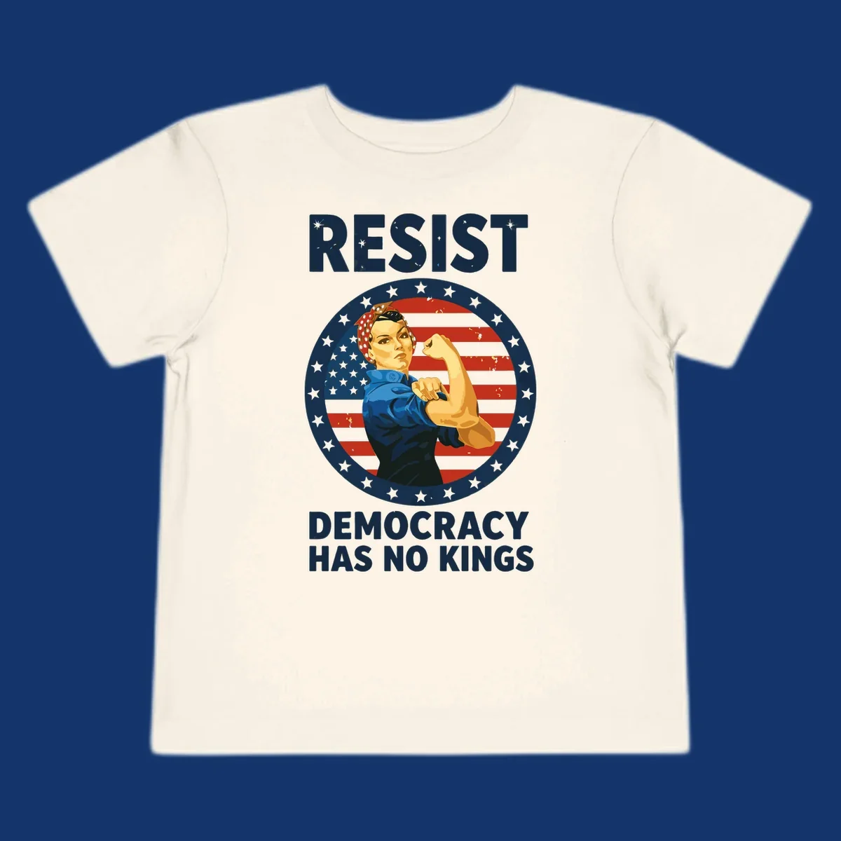 A Rosie the Riveter-style woman flexing her arm against a distressed American flag, with 'RESIST' and 'DEMOCRACY HAS NO KINGS' text. This design embodies the rosie-riveter-resist concept.