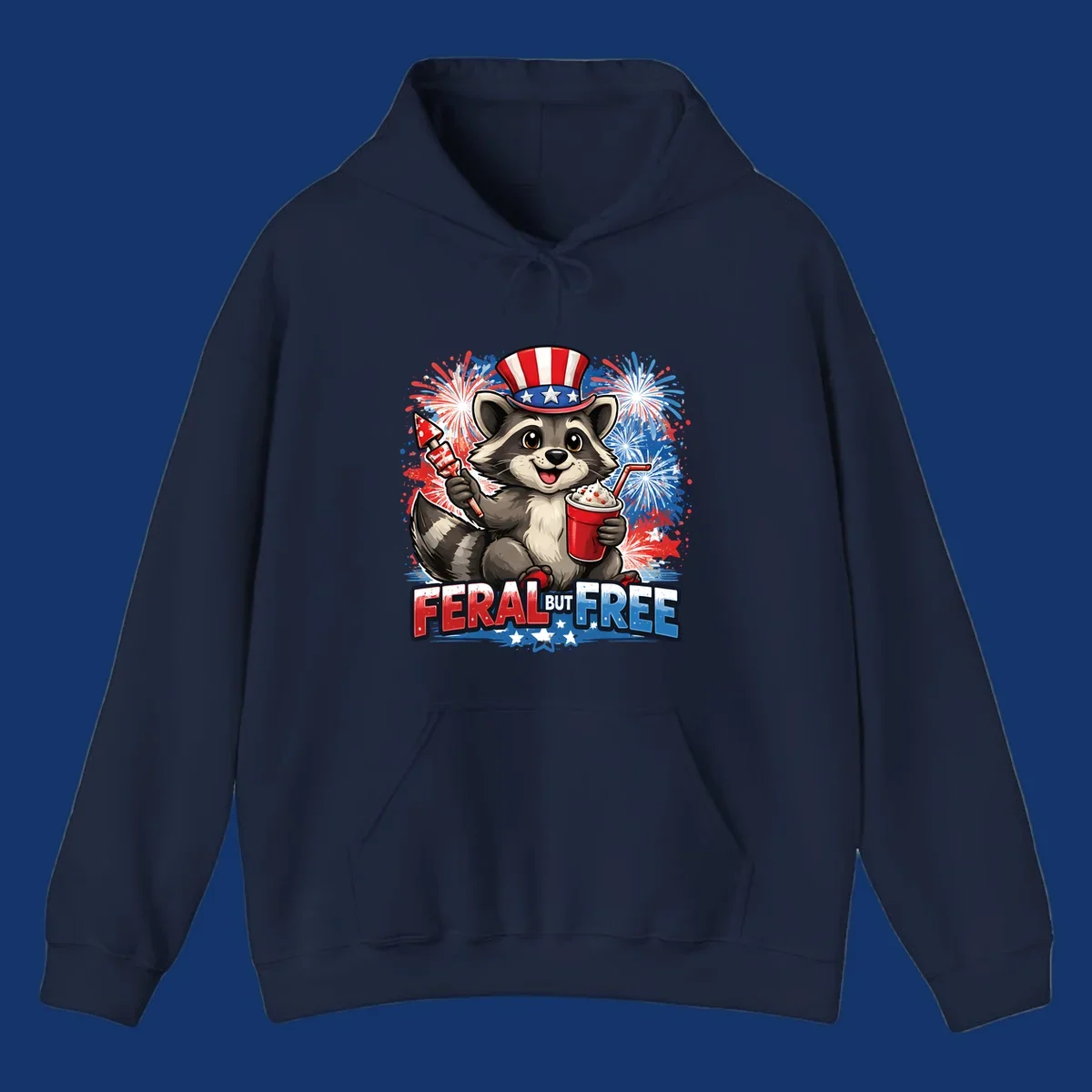 A cartoon raccoon in an Uncle Sam hat holds a firework and drink, with red, white, and blue fireworks and "FERAL BUT FREE" text.