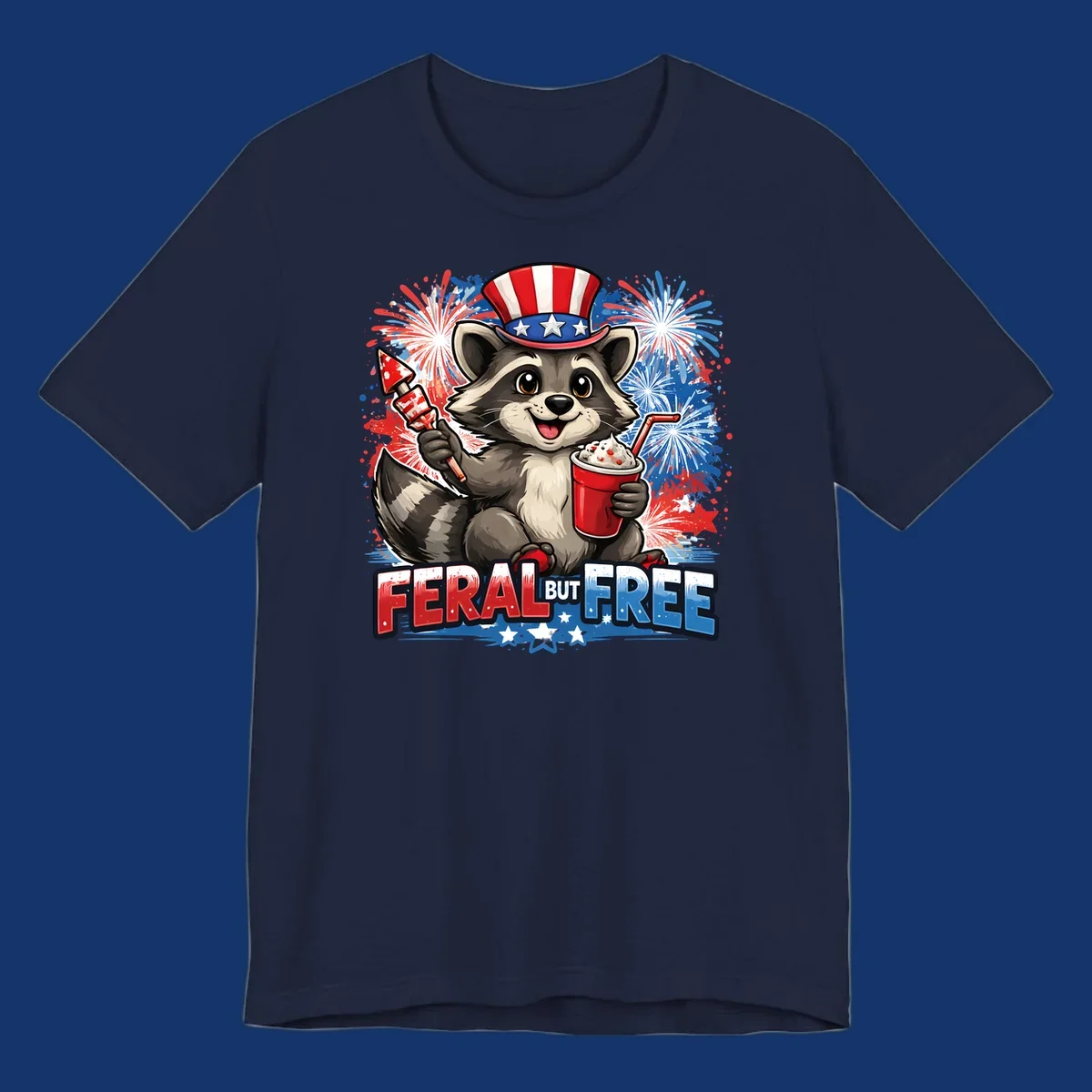 A cartoon raccoon in an Uncle Sam hat holds a firework and drink, with red, white, and blue fireworks and "FERAL BUT FREE" text.