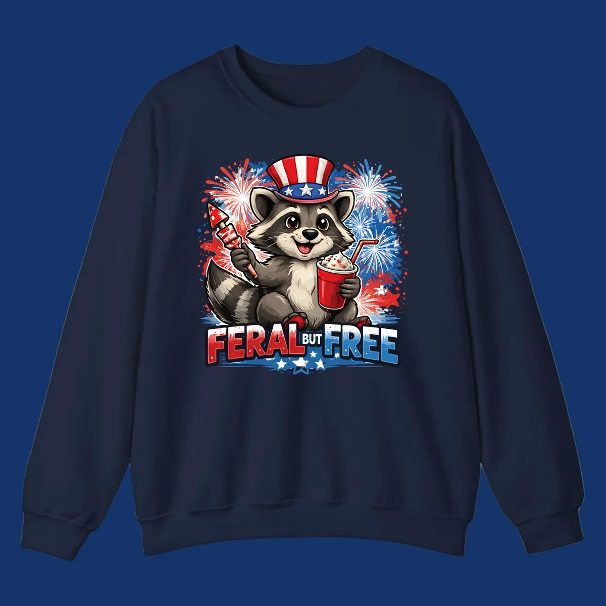 A cartoon raccoon in an Uncle Sam hat holds a firework and drink, with red, white, and blue fireworks and "FERAL BUT FREE" text.