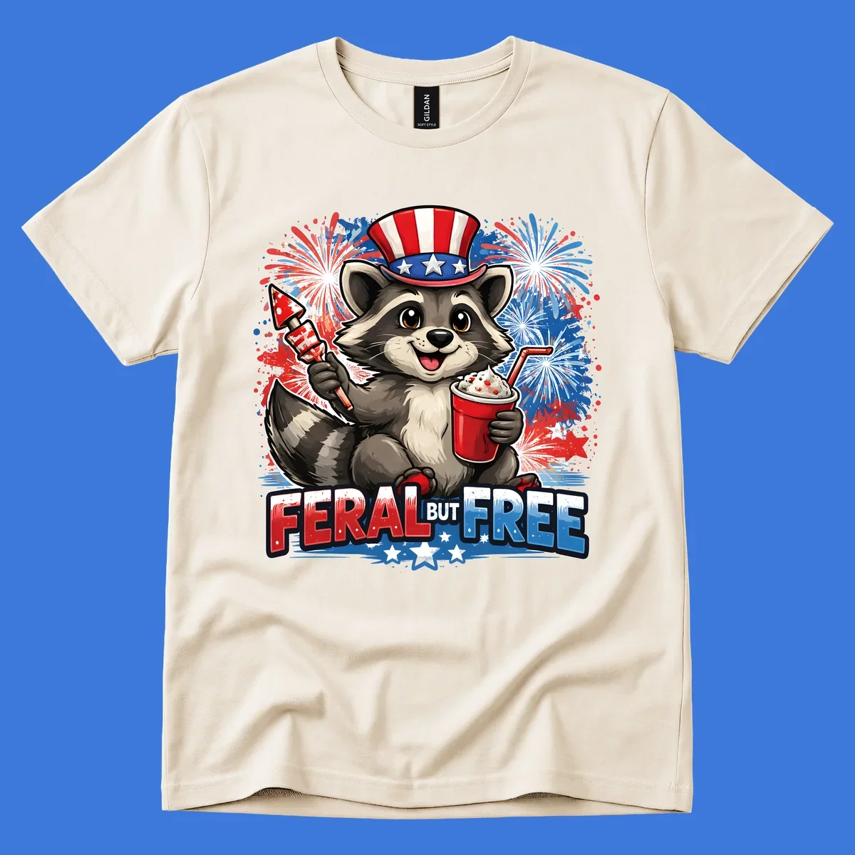 A cartoon raccoon in an Uncle Sam hat holds a firework and drink, with red, white, and blue fireworks and "FERAL BUT FREE" text.