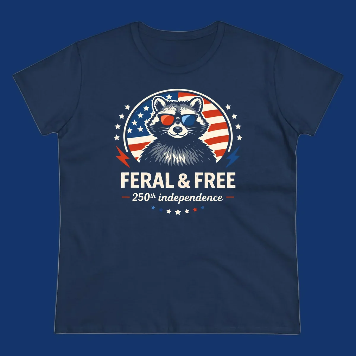 A patriotic design with a raccoon in red and blue sunglasses against an American flag, with text 'Feral & Free 250th Independence'.
