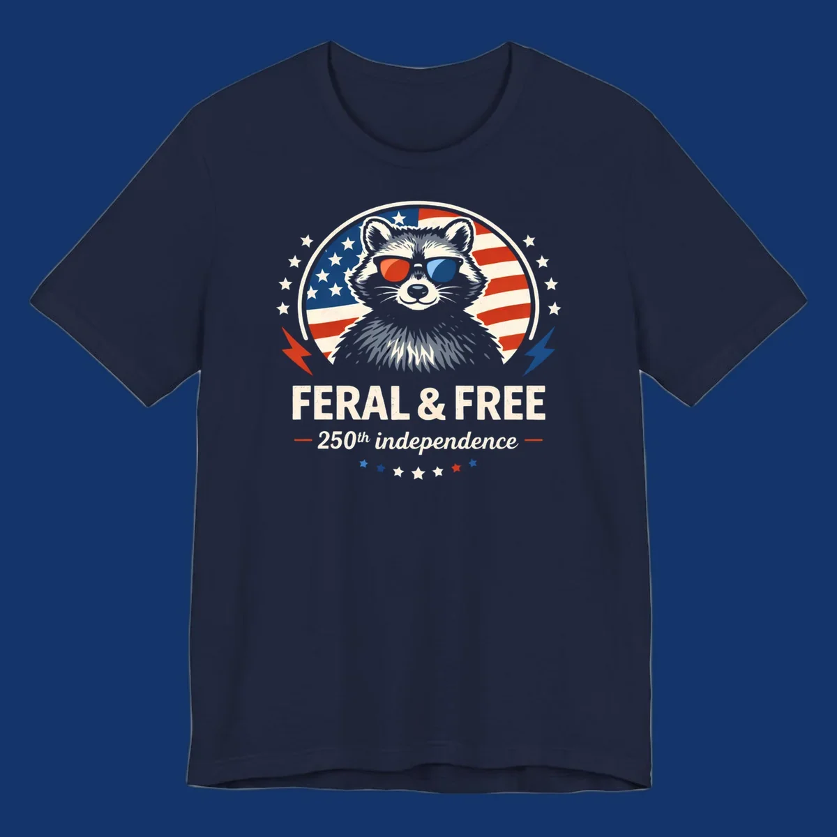 A patriotic design with a raccoon in red and blue sunglasses against an American flag, with text 'Feral & Free 250th Independence'.