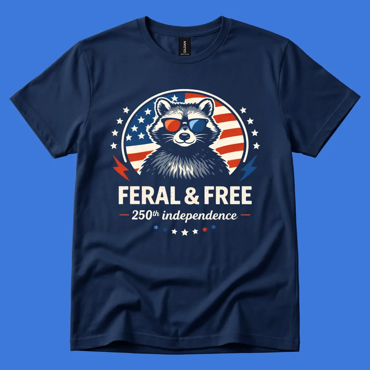 A patriotic design with a raccoon in red and blue sunglasses against an American flag, with text 'Feral & Free 250th Independence'.