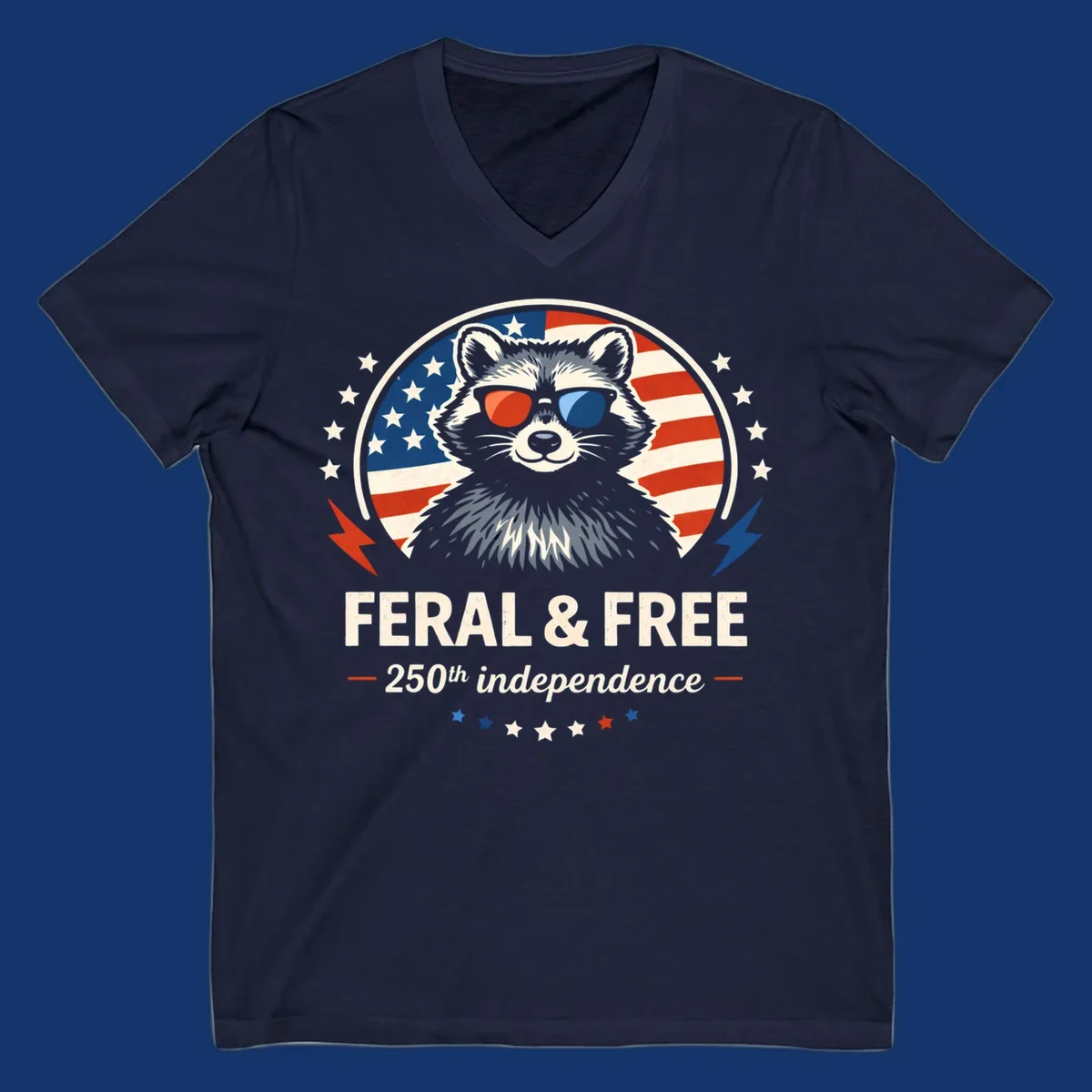 A patriotic design with a raccoon in red and blue sunglasses against an American flag, with text 'Feral & Free 250th Independence'.