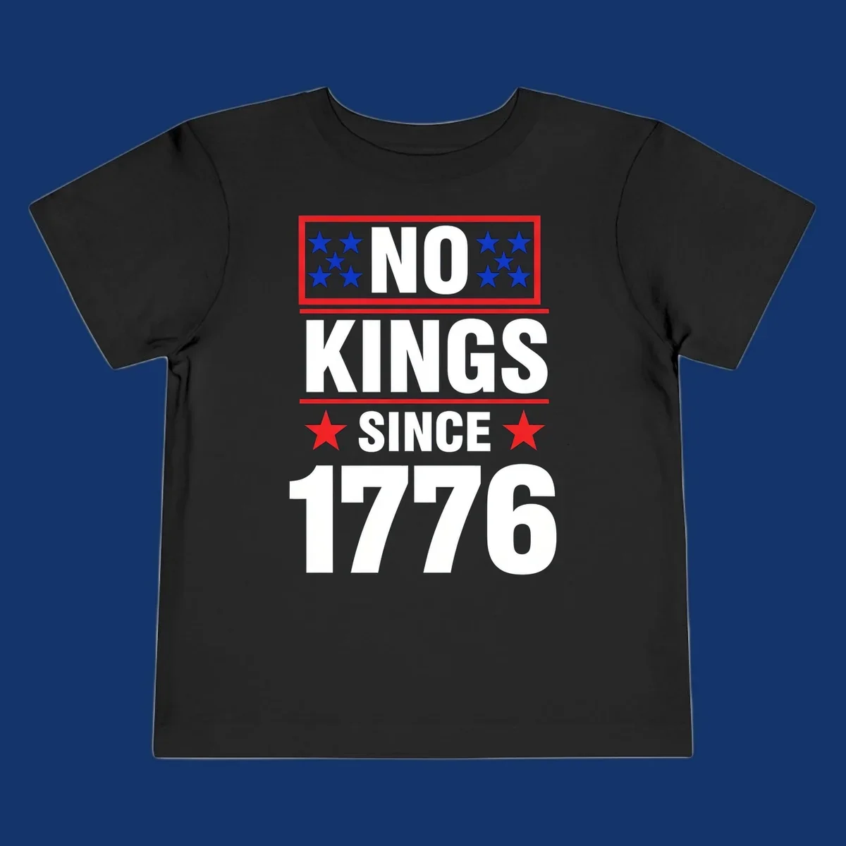 A patriotic design with the text 'NO KINGS SINCE 1776' in white and navy, featuring blue and red stars.