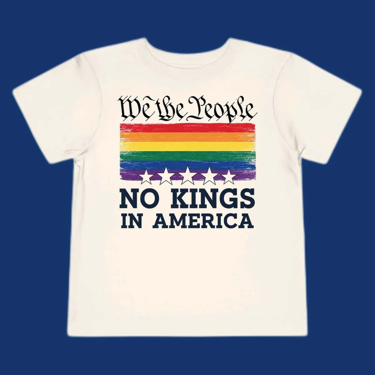 A distressed rainbow flag with five stars, 'We the People' above and 'NO KINGS IN AMERICA' below, symbolizing we-the-people-no-kings-pride.