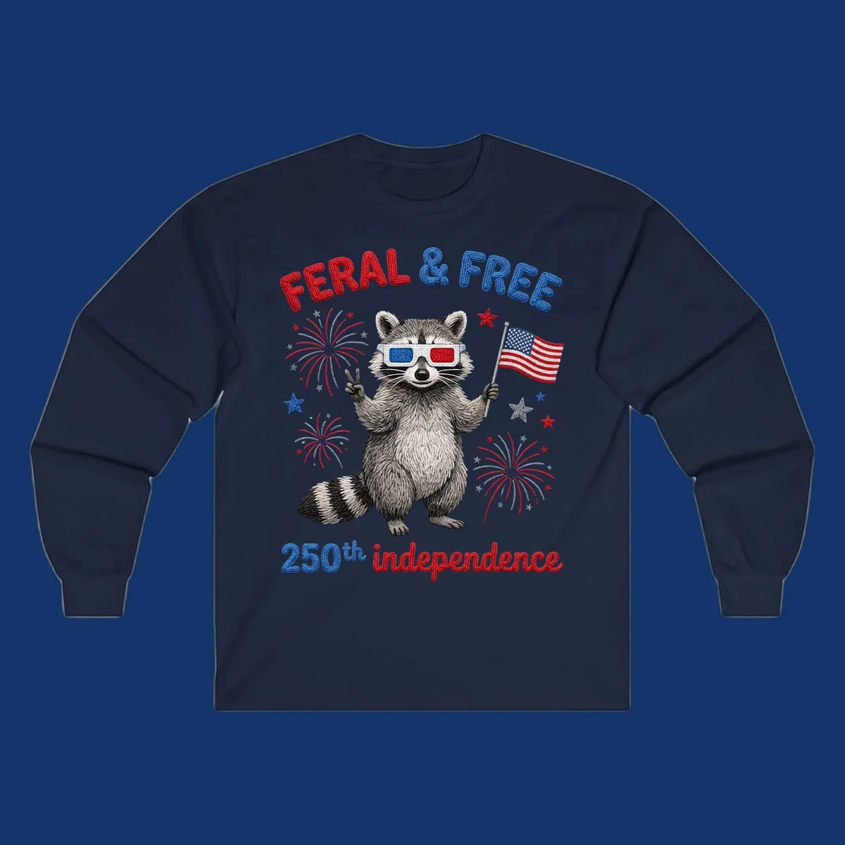 A playful raccoon in 3D glasses holds an American flag, surrounded by fireworks and stars, with "FERAL & FREE 250th independence".