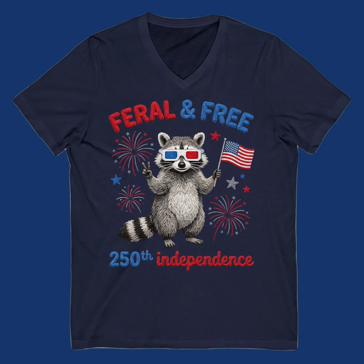 A playful raccoon in 3D glasses holds an American flag, surrounded by fireworks and stars, with "FERAL & FREE 250th independence".
