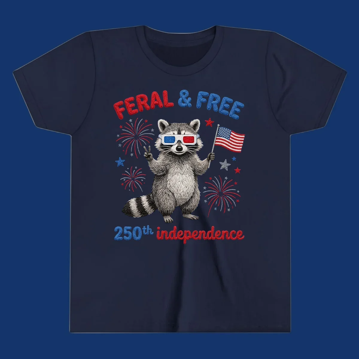 A playful raccoon in 3D glasses holds an American flag, surrounded by fireworks and stars, with "FERAL & FREE 250th independence".