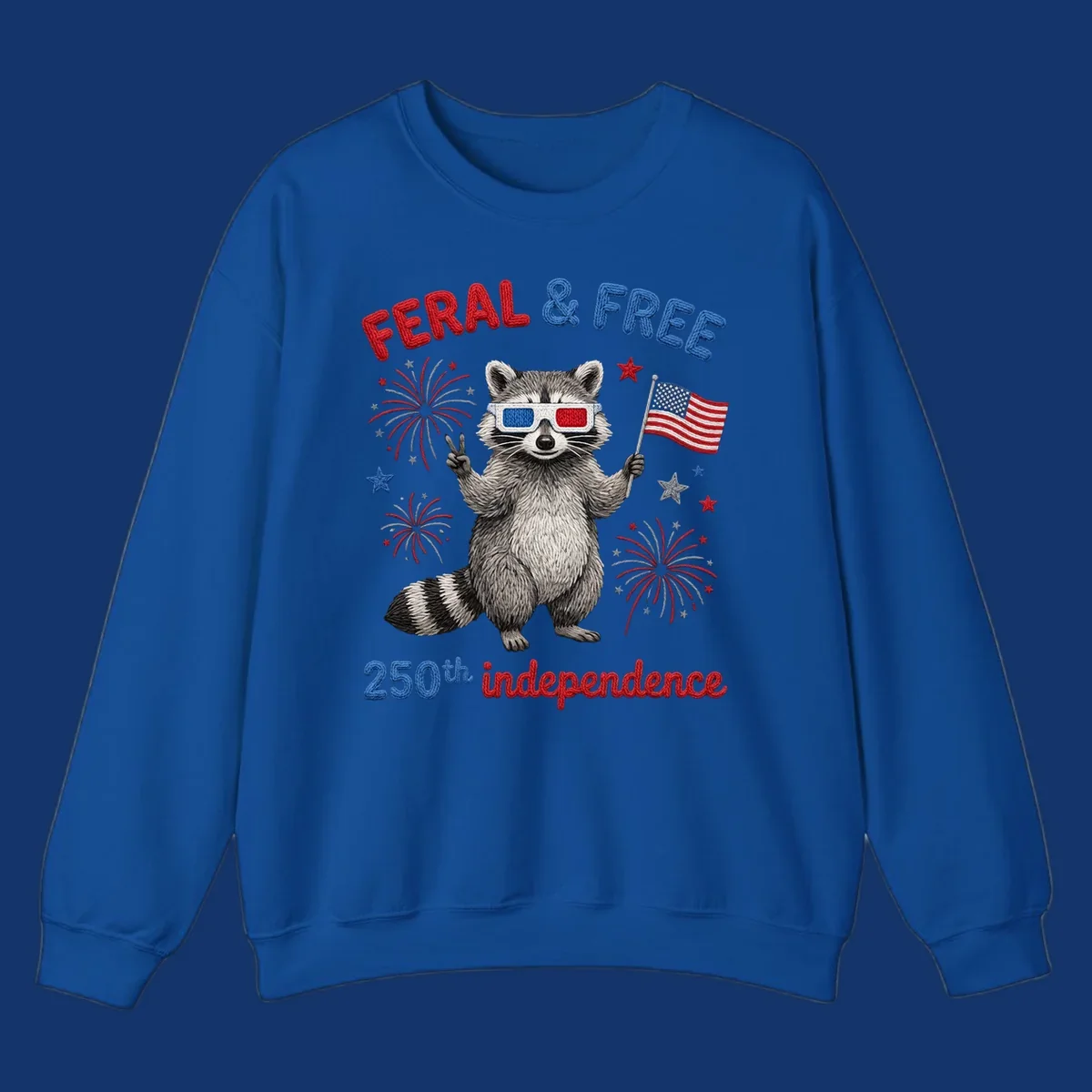 A "FERAL & FREE" raccoon in 3D glasses holds an American flag, surrounded by fireworks, celebrating 250th independence.