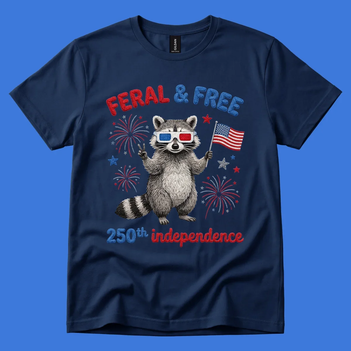 A "FERAL & FREE" raccoon in 3D glasses holds an American flag, surrounded by fireworks, celebrating 250th independence.