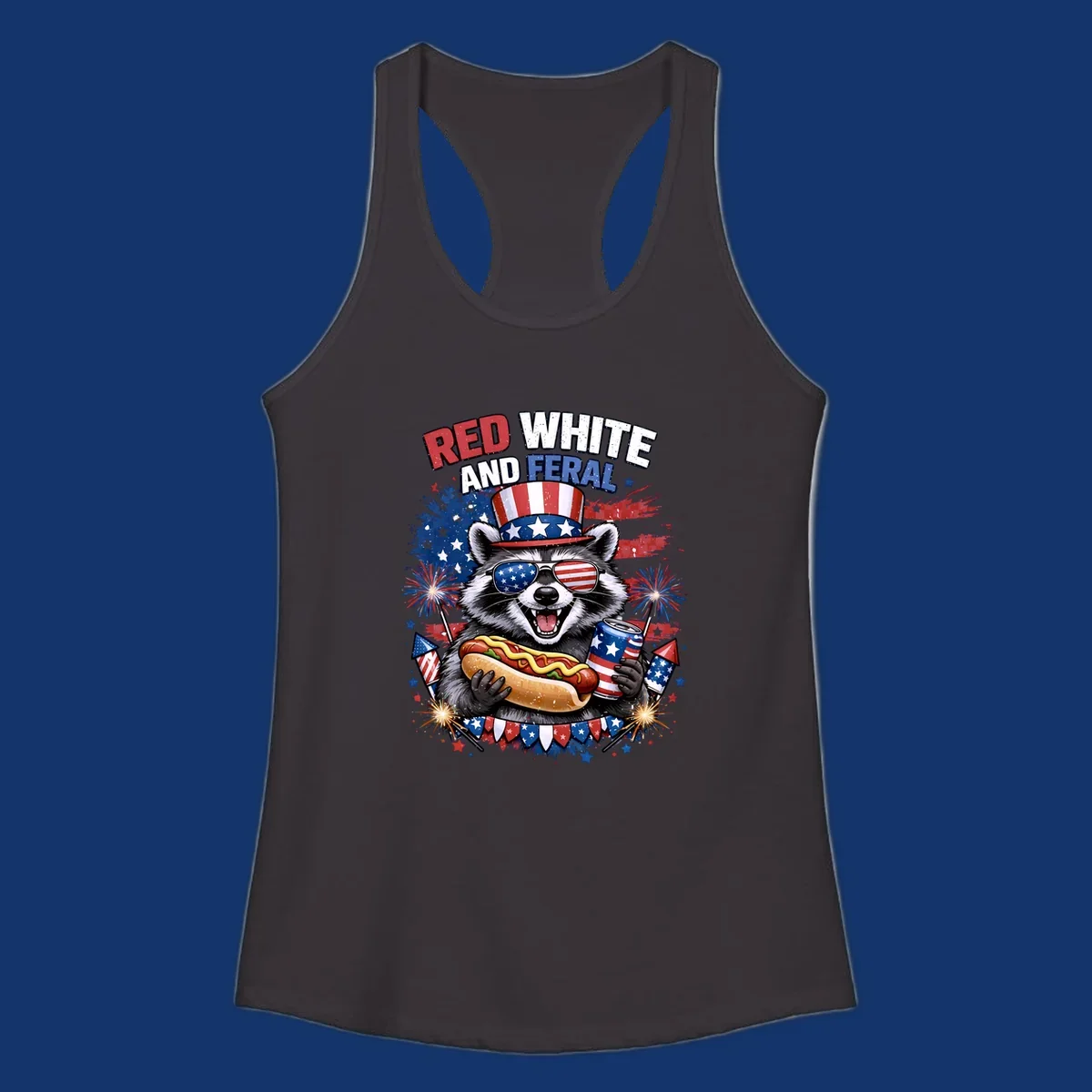 A patriotic raccoon wearing an American flag top hat and sunglasses, holding a hot dog and soda can, with the text 'RED WHITE AND FERAL' and fireworks.