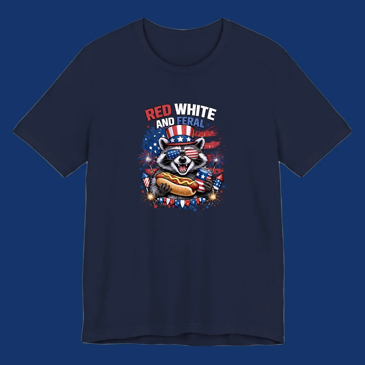 A patriotic raccoon wearing an American flag top hat and sunglasses, holding a hot dog and soda can, with the text 'RED WHITE AND FERAL' and fireworks.