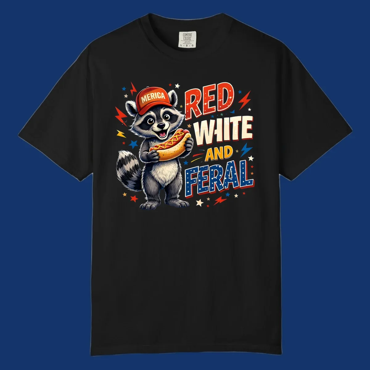 A happy raccoon in a 'MERICA' hat holds a hot dog, with 'RED WHITE AND FERAL' text, stars, and lightning bolts. Features a raccoon-merica-feral-hotdog theme.