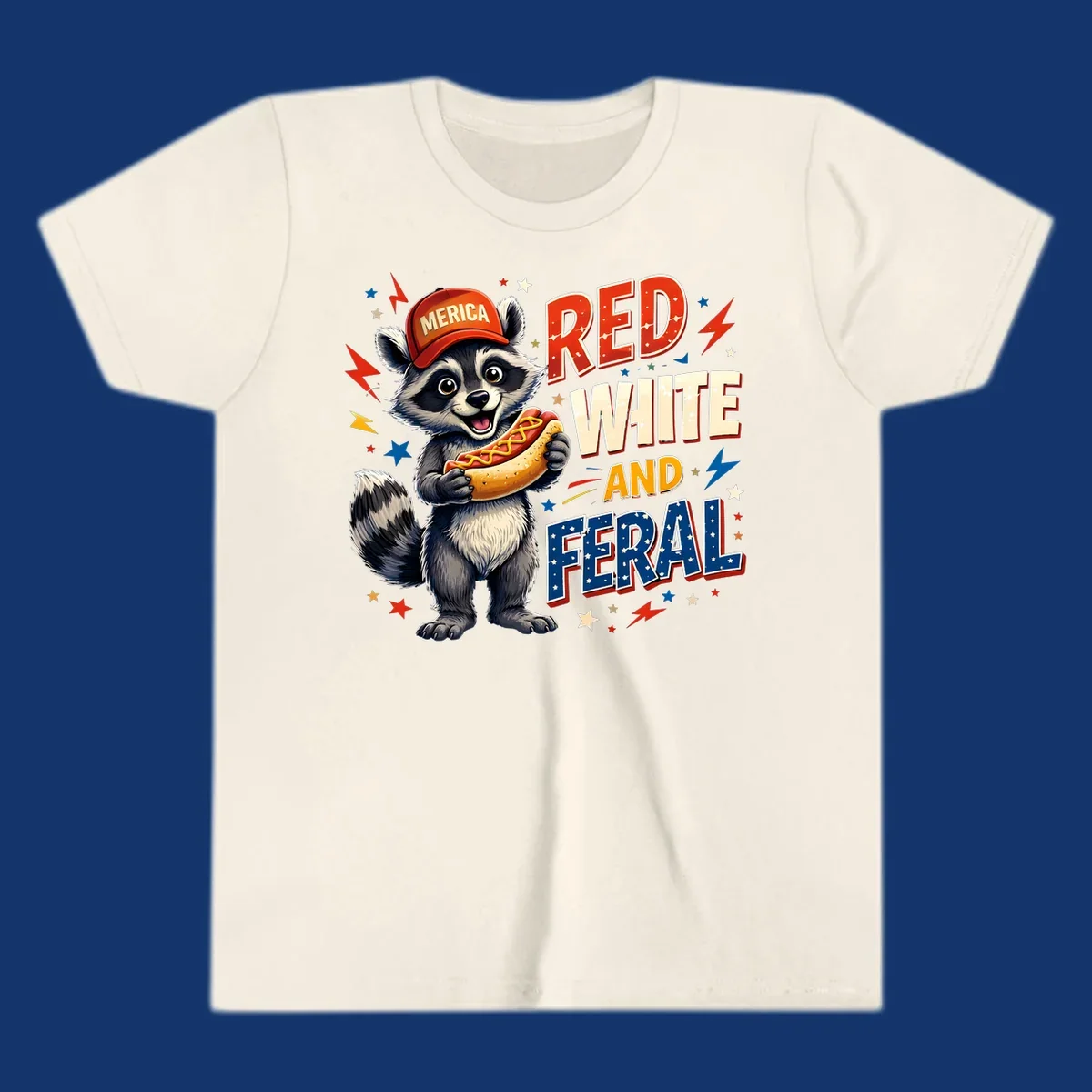 A happy raccoon in a 'MERICA' hat holds a hot dog, with 'RED WHITE AND FERAL' text, stars, and lightning bolts. Features a raccoon-merica-feral-hotdog theme.